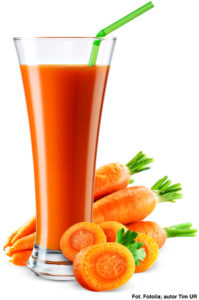 Glass of carrot juice with fruit isolated on white.